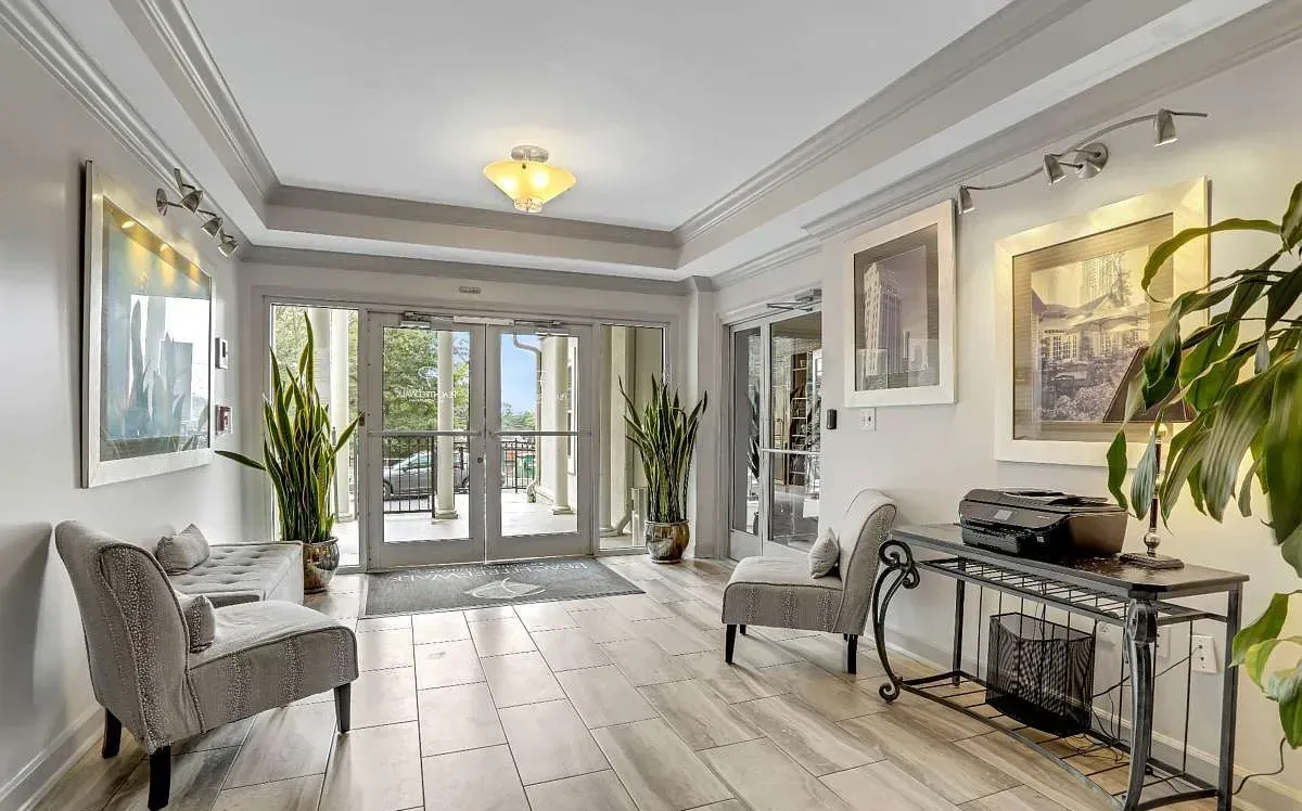 The residential lobby with tile floors, seating, and framed skyline art